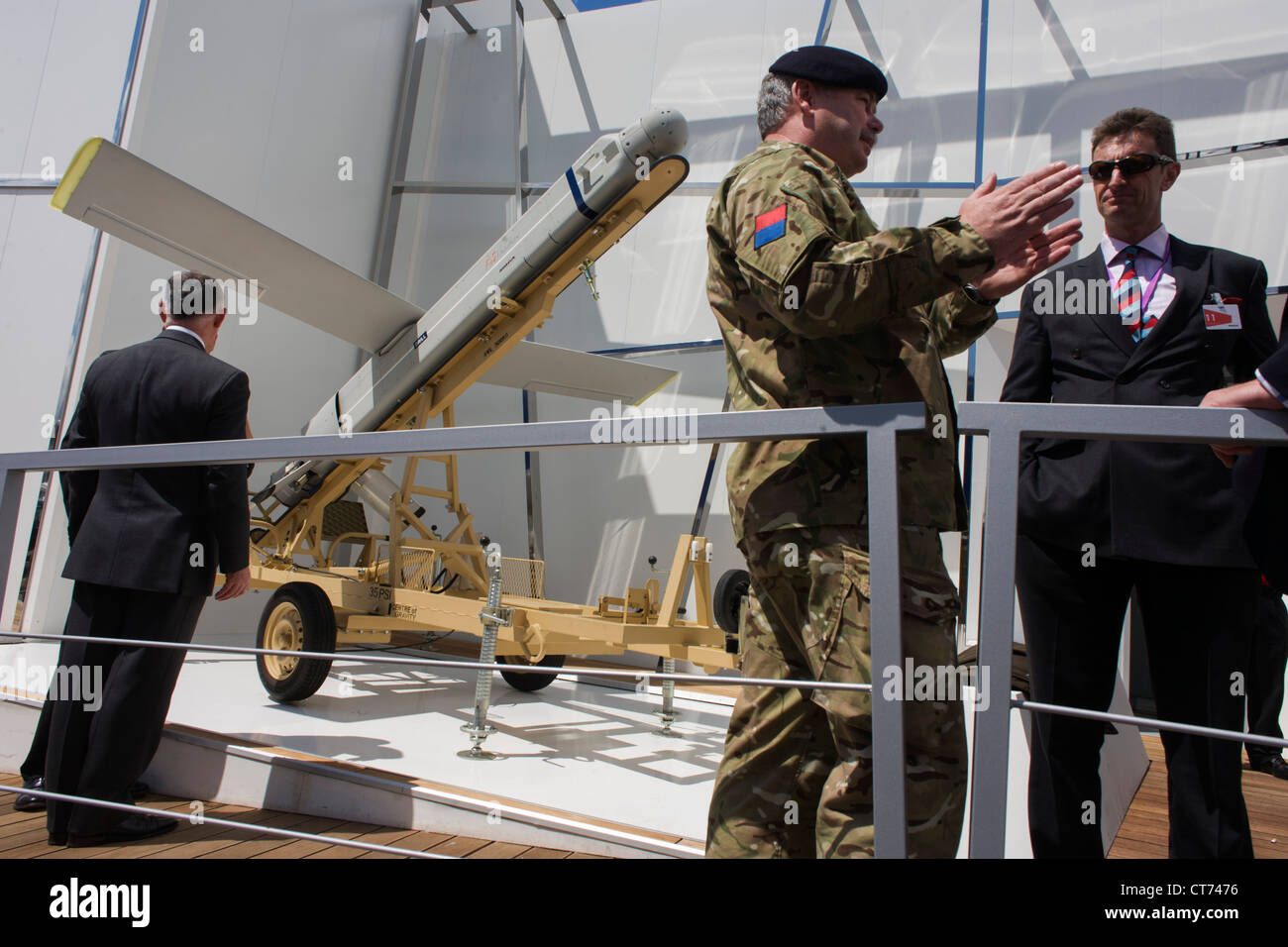 A soldier from the British Royal Artillery demonstrates details of Fire Shadow missile on MBDA's trade stand at Farnborough airshow. Stock Photo