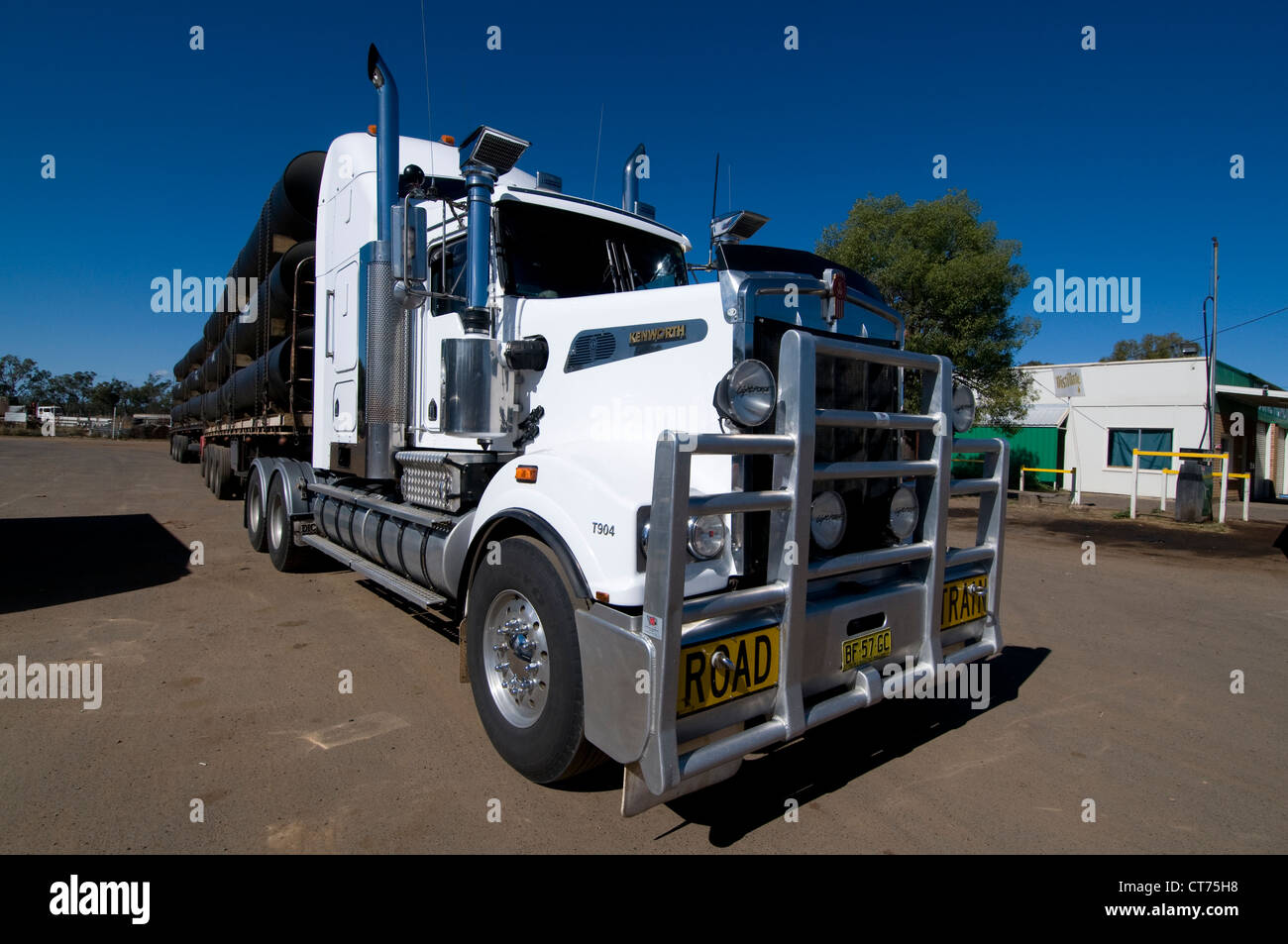 A parked road train with its load of water pipes at a lorry park in a small rural town of Injune on the Carnarvon Highway in western Queensland, Stock Photo