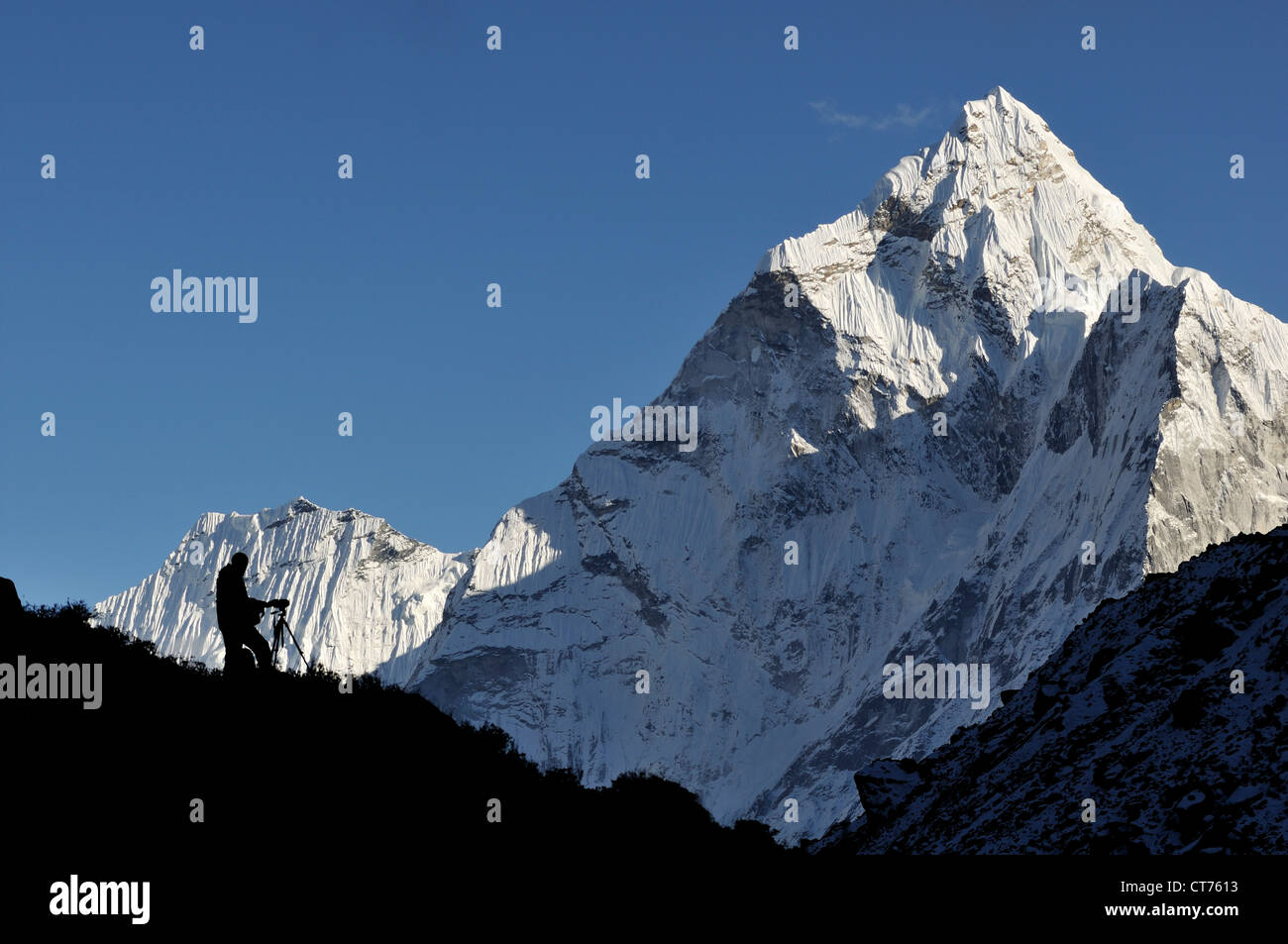 photographer on Nepal mountain with Ama Dablam in background Stock Photo