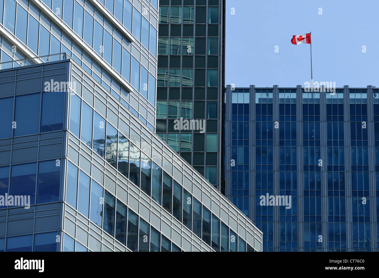 canadian flag waving on top of skyscraper in vancouver Stock Photo
