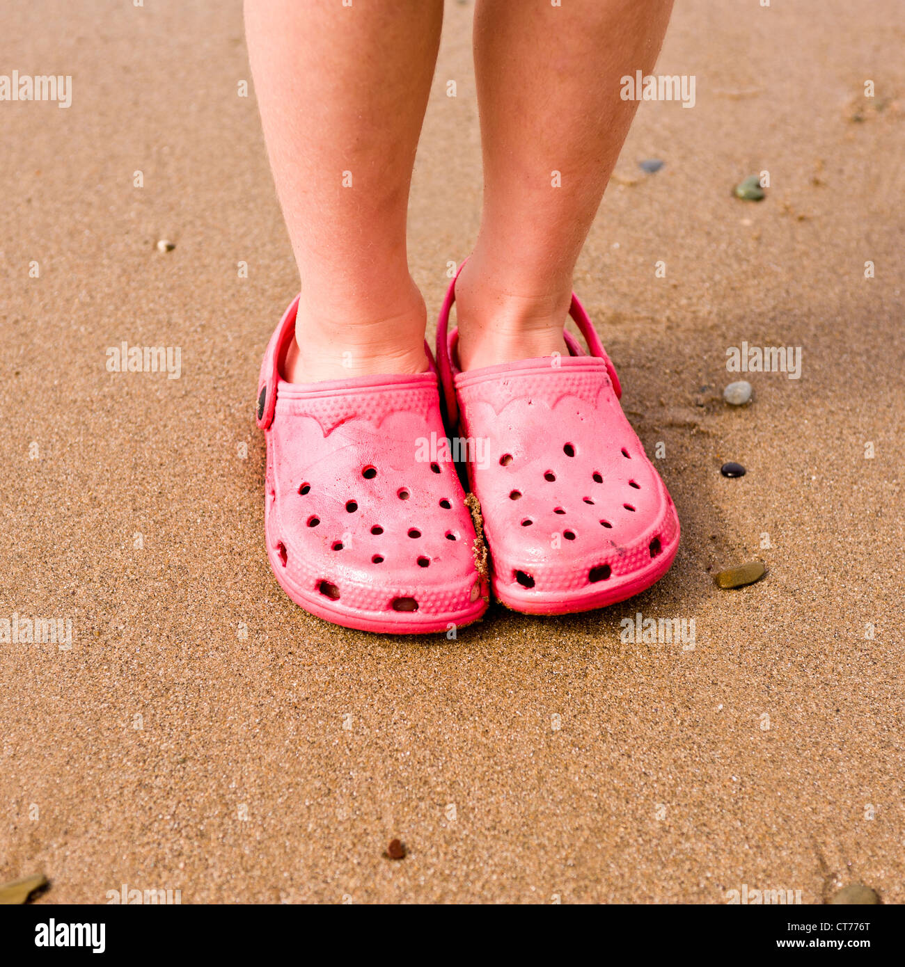 crocs with feet painted on them