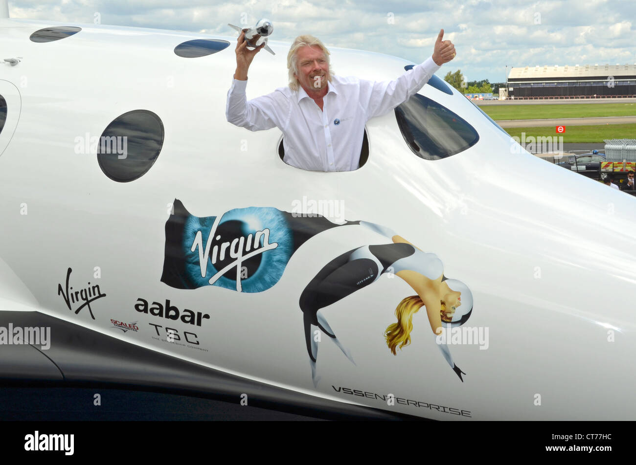 Sir Richard Branson, Founder of Virgin Galactic, with a model of LauncherOne in a replica of SpaceShipTwo. Stock Photo