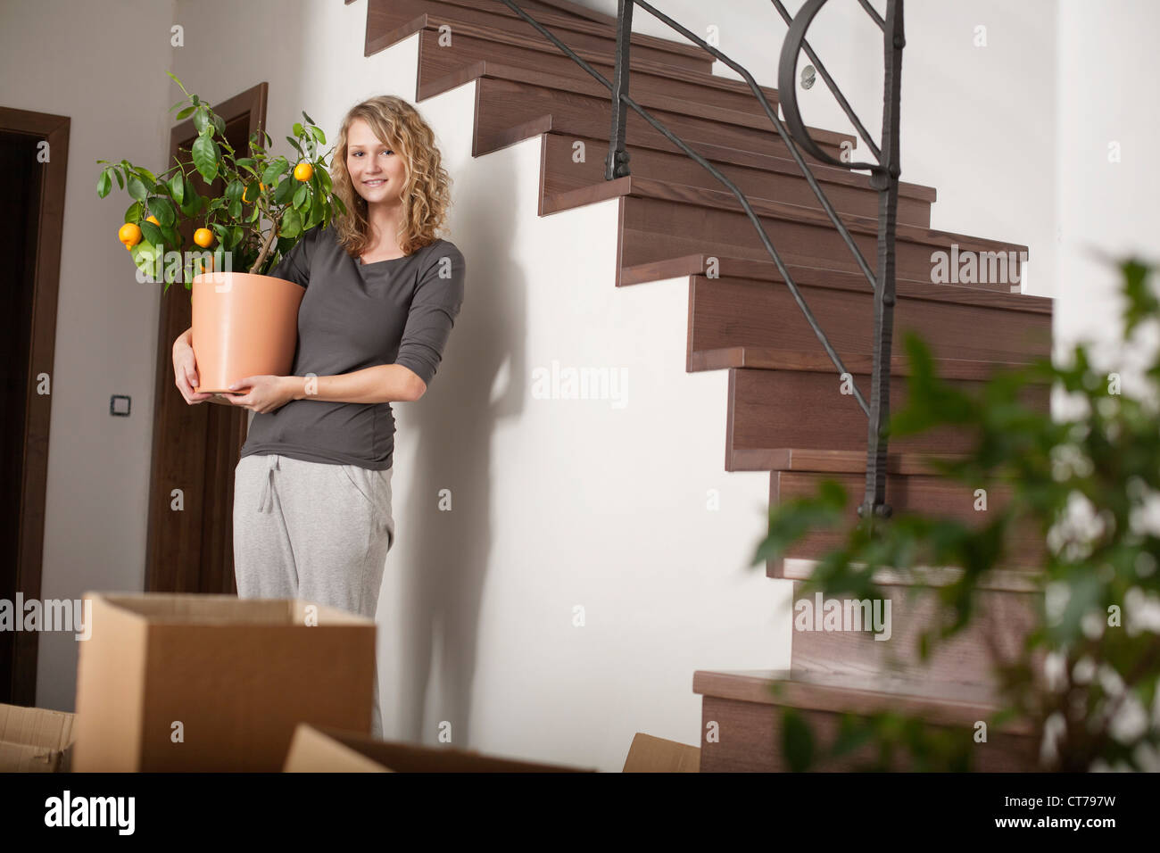 portrait of young woman in new home Stock Photo - Alamy