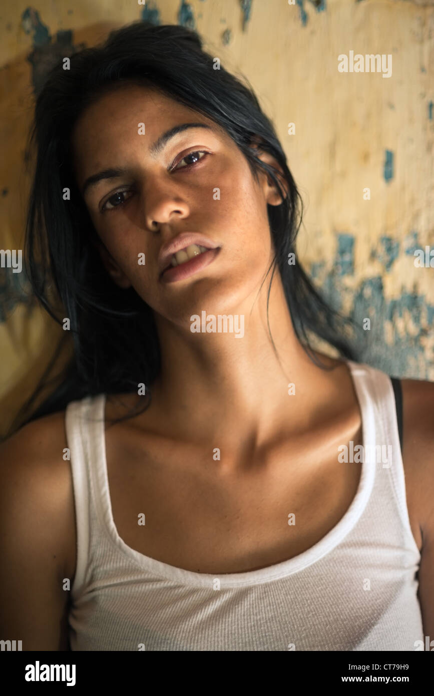Domestic violence, portrait of abused and hurt young woman crying at home Stock Photo