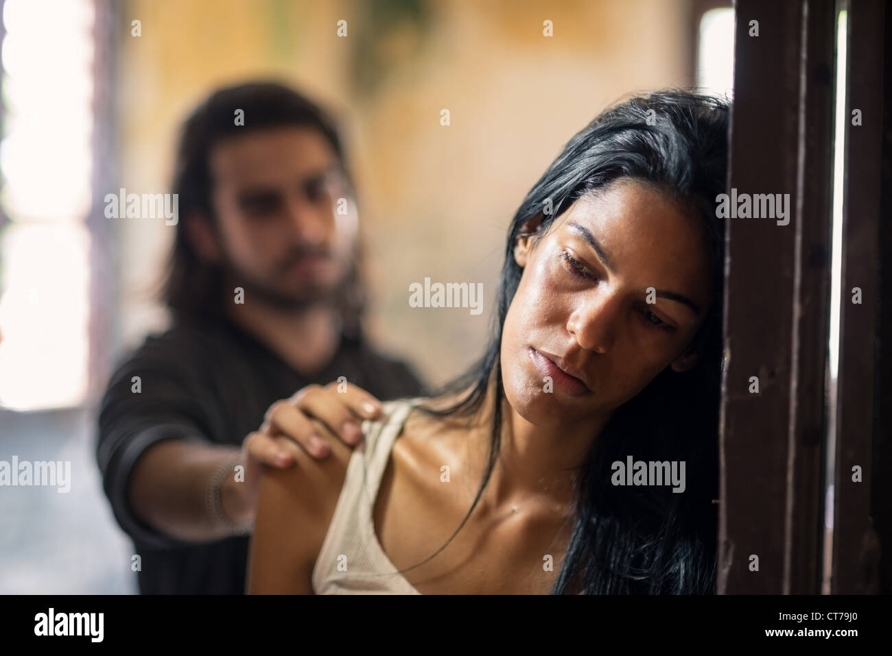 Social issues, domestic violence with young husband trying to reconcile with abused wife Stock Photo