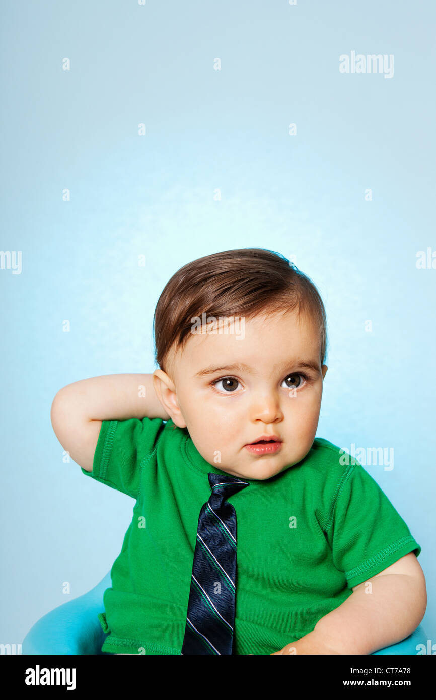 Baby boy wearing green top and tie Stock Photo