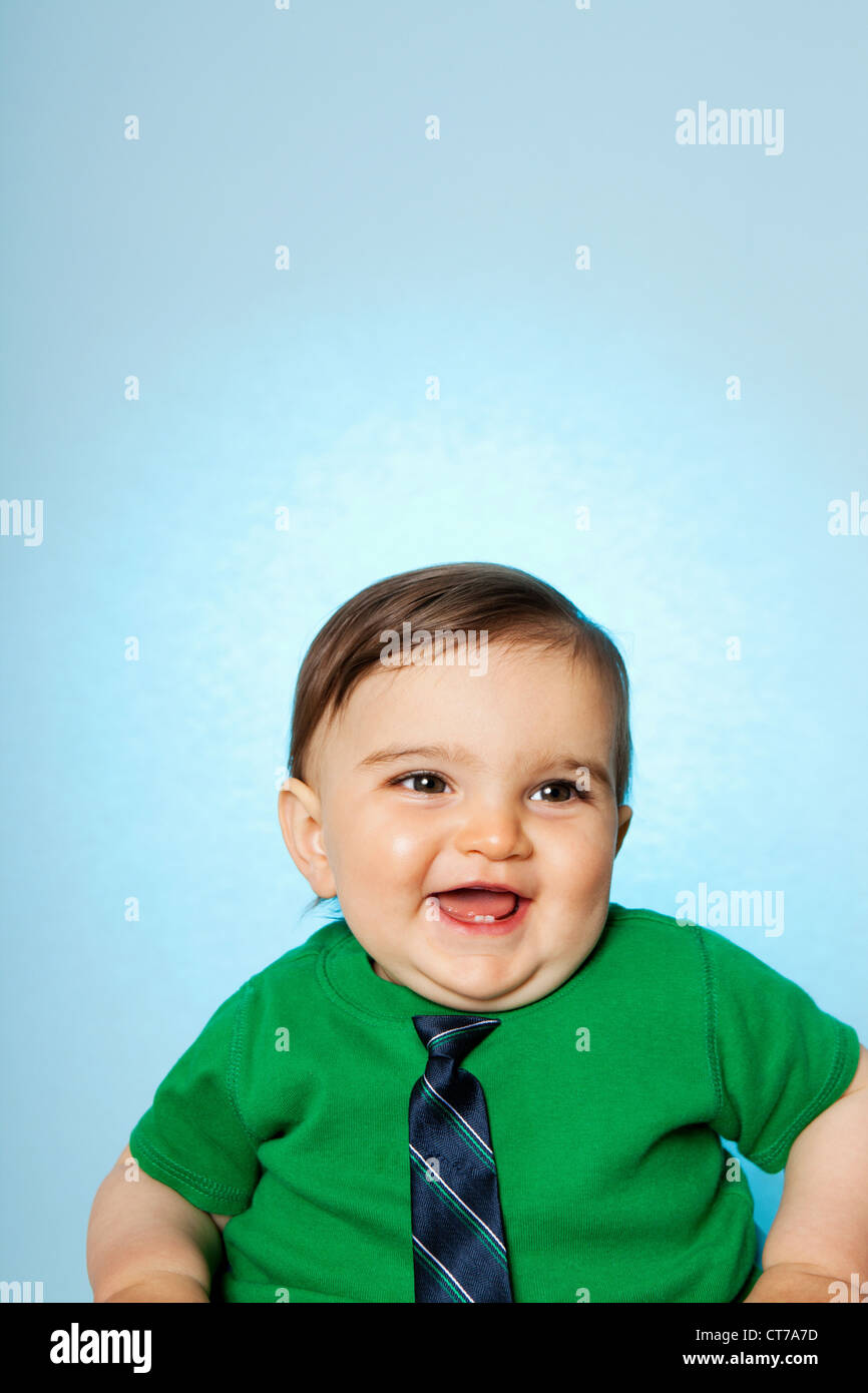 Baby boy wearing green top and tie Stock Photo