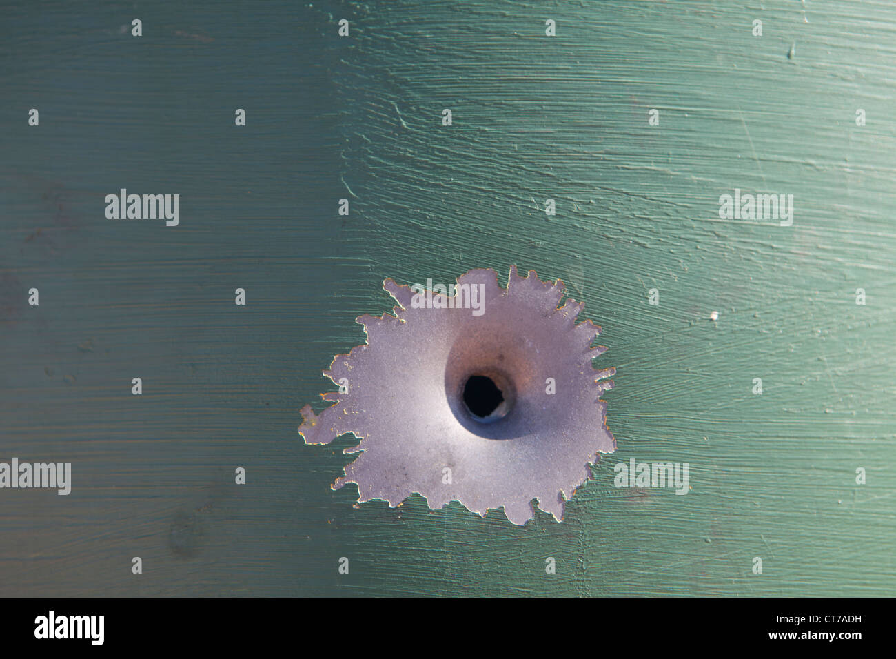 Bullet hole in a metal post in outback Australia Stock Photo
