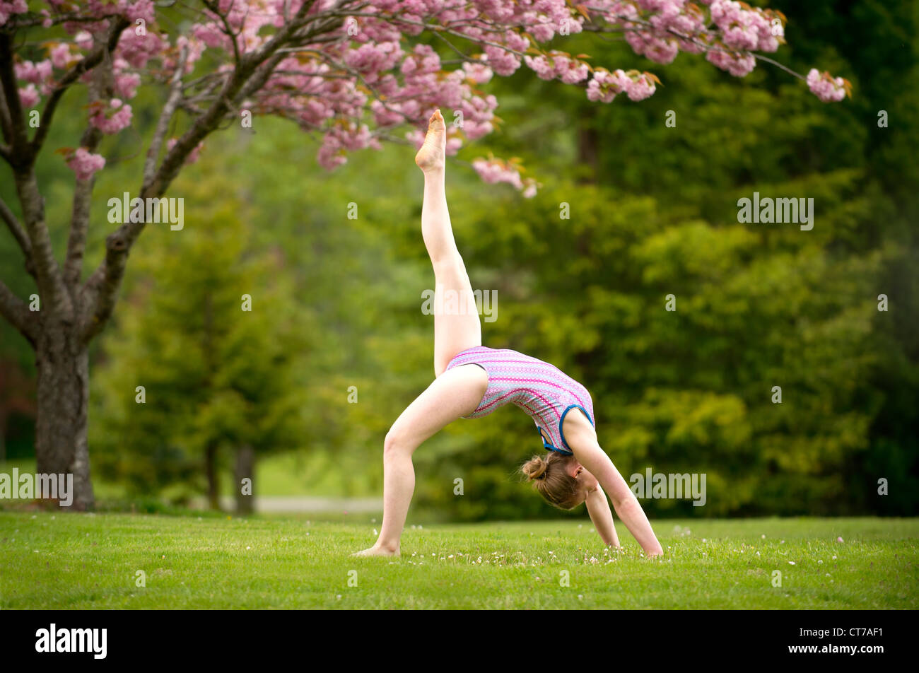 Gymnast performing in park Stock Photo