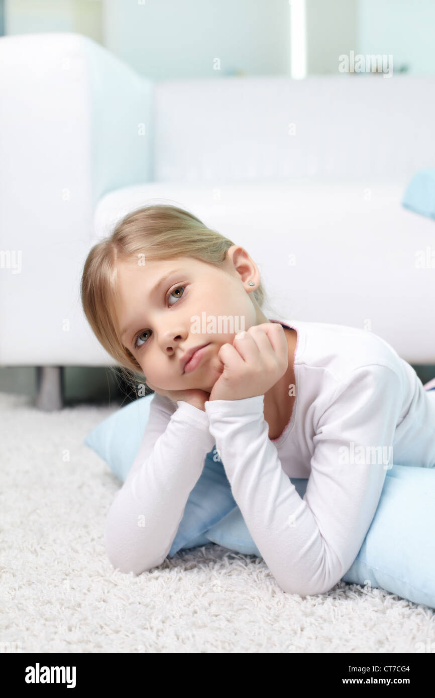 Portrait of lovely girl lying on the floor at home Stock Photo - Alamy
