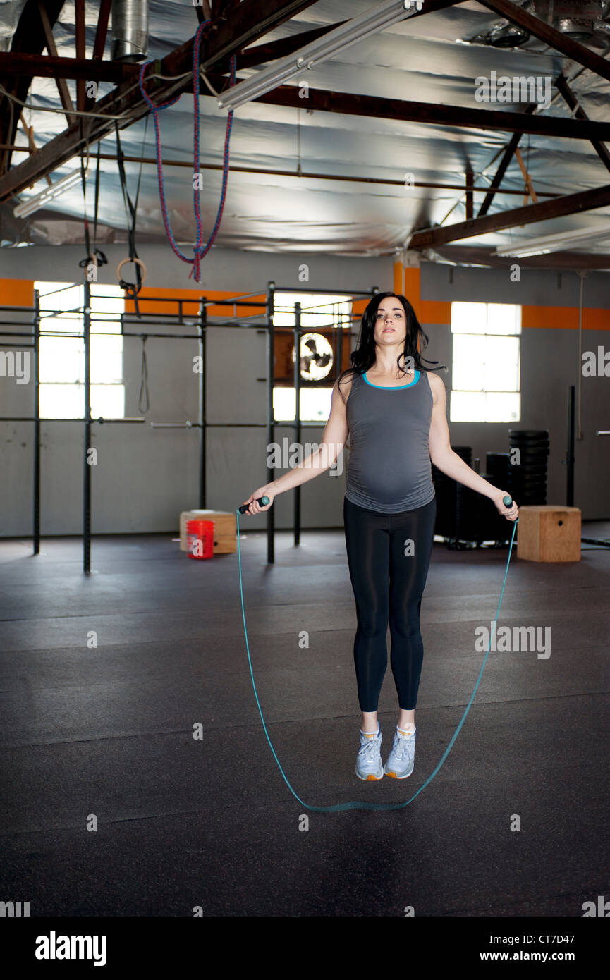 Pregnant young woman skipping with rope Stock Photo Alamy