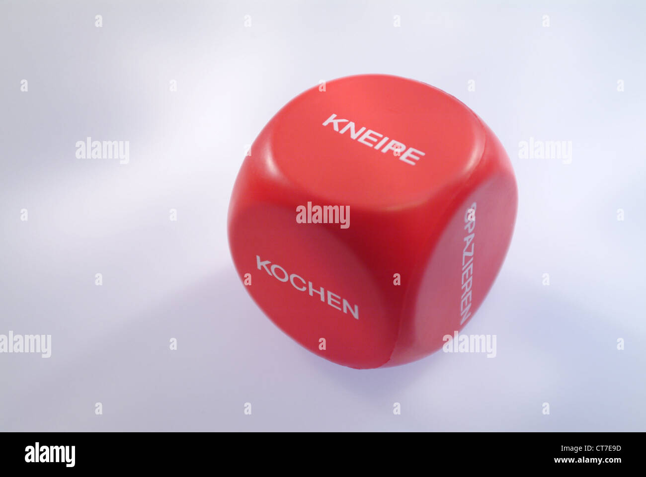 A red Spielwuerfel with words rather than numbers Stock Photo