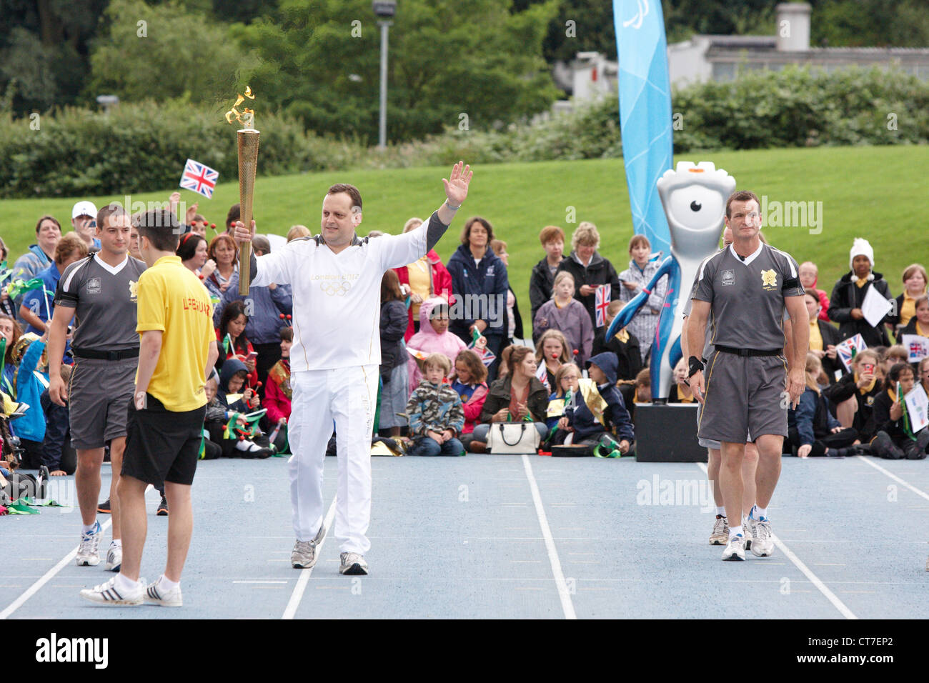 Ian Estick leaves Stoke Mandeville Stadium carrying the Olympic Torch on Day 52 of the Relay through Britain. Stock Photo