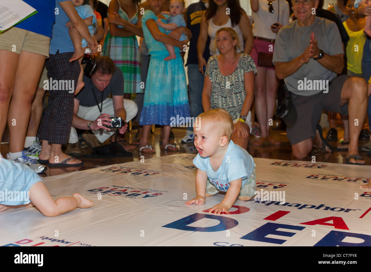 Babies crawl to the finish line in a Diaper Derby in New York Stock