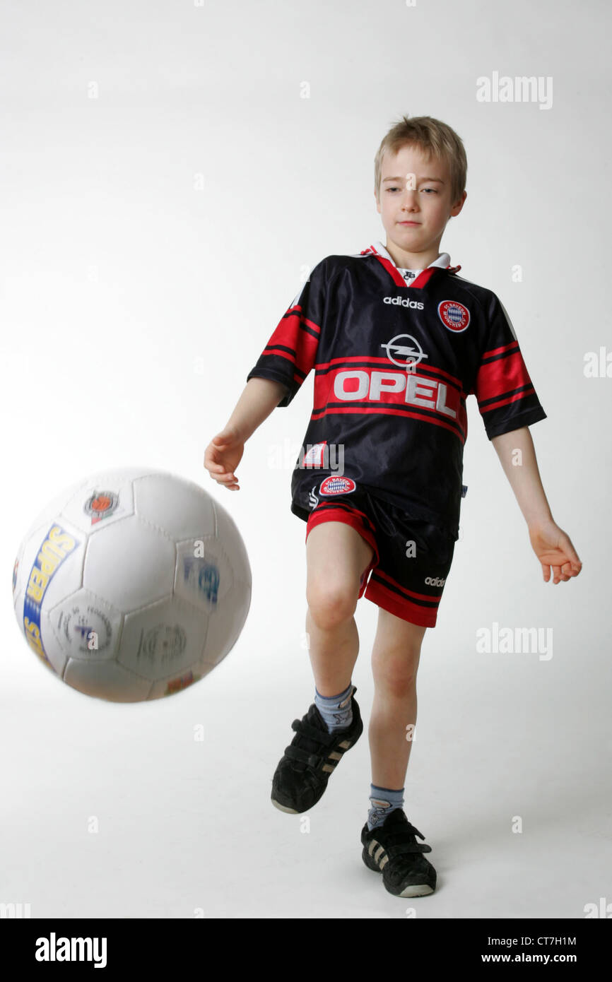 A boy shoots a soccer ball Stock Photo Alamy
