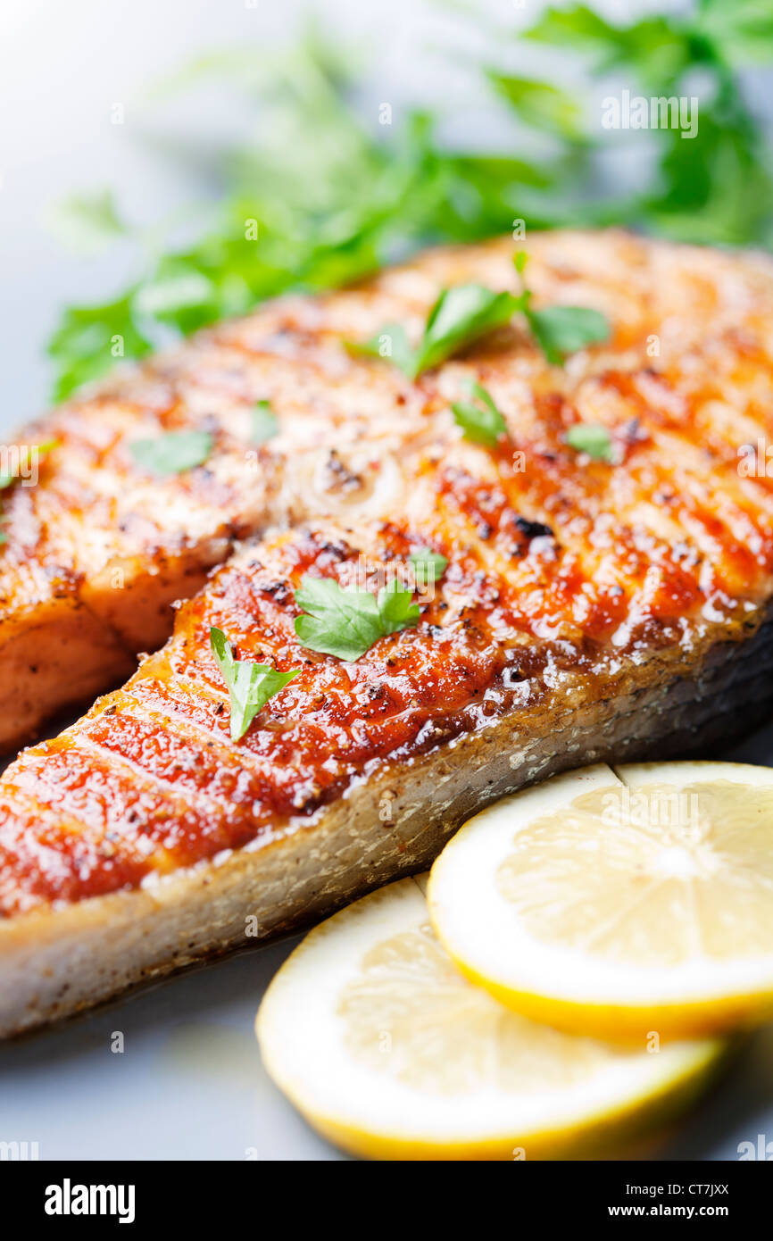 crispy grilled salmon steak with cherry tomatoes and parsley Stock Photo