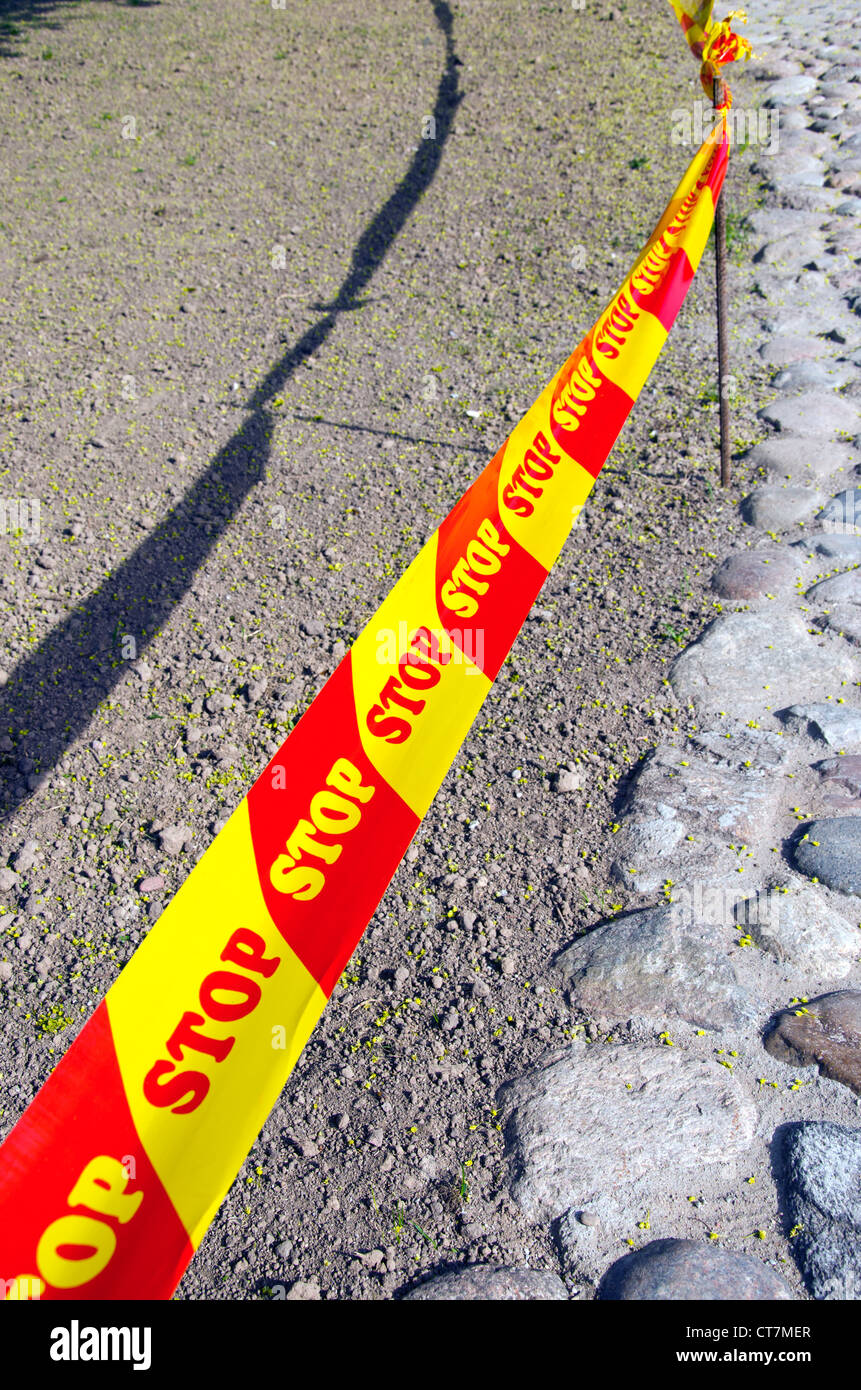 warning red and yellow tape stop on the road Stock Photo