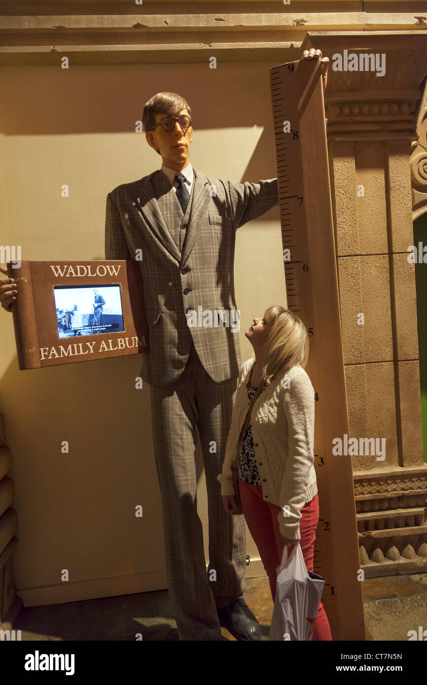 Worlds tallest man, Wadlow next to 5 foot tall tourist in on display in