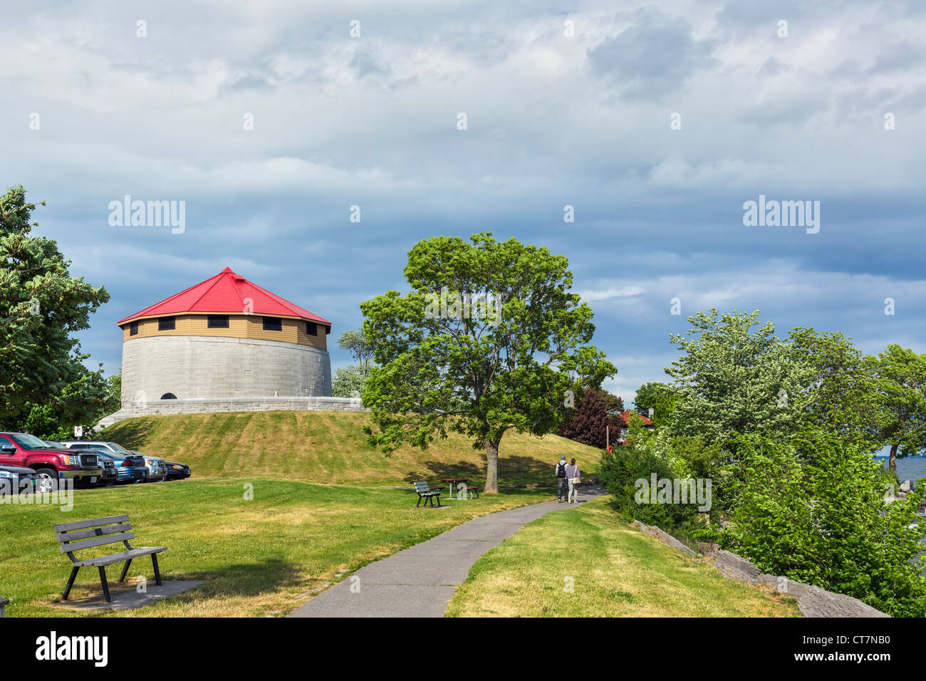 Couple walking along the shores of Lake Ontario in MacDonald Park by the historic Murney Tower, Kingston, Ontario, Canada Stock Photo