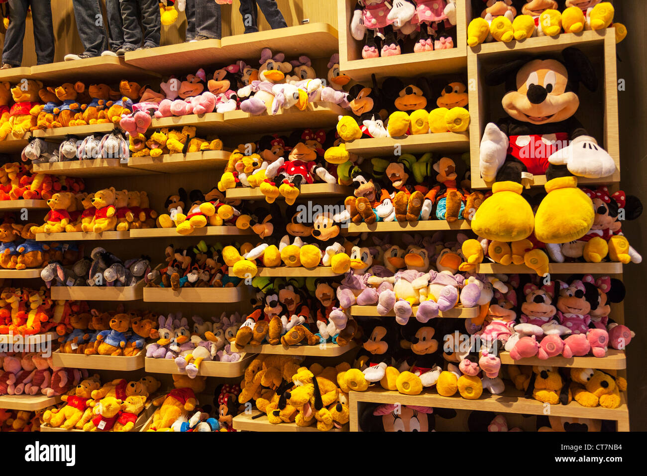 Iconic Disney characters Micky Mouse, Minny, goofy, teddy bears on shelves in Disney store Manhattan, New York City Stock Photo