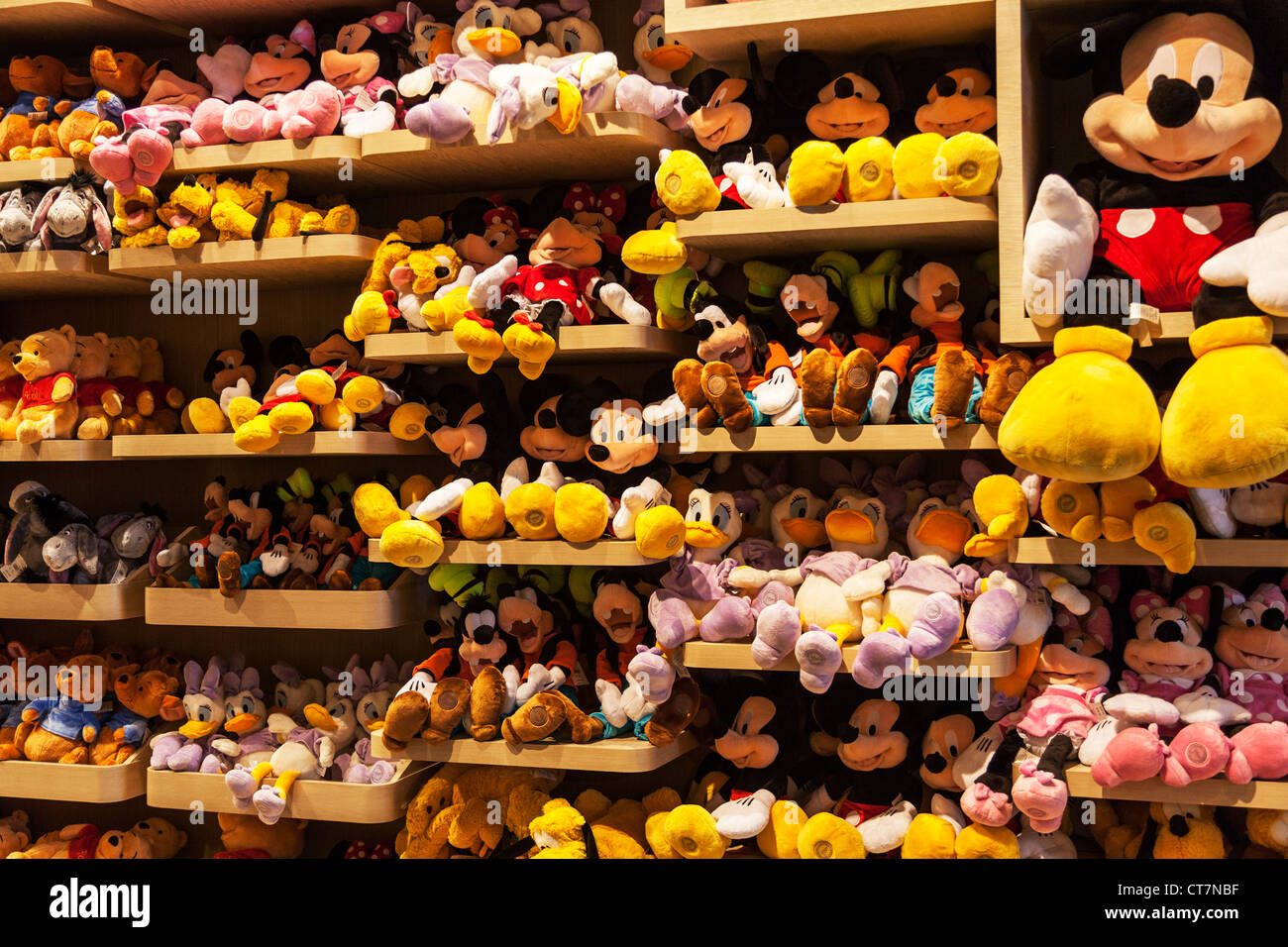 Iconic Disney characters Micky Mouse, Minny, goofy, teddy bears on shelves in Disney store Manhattan, New York City Stock Photo