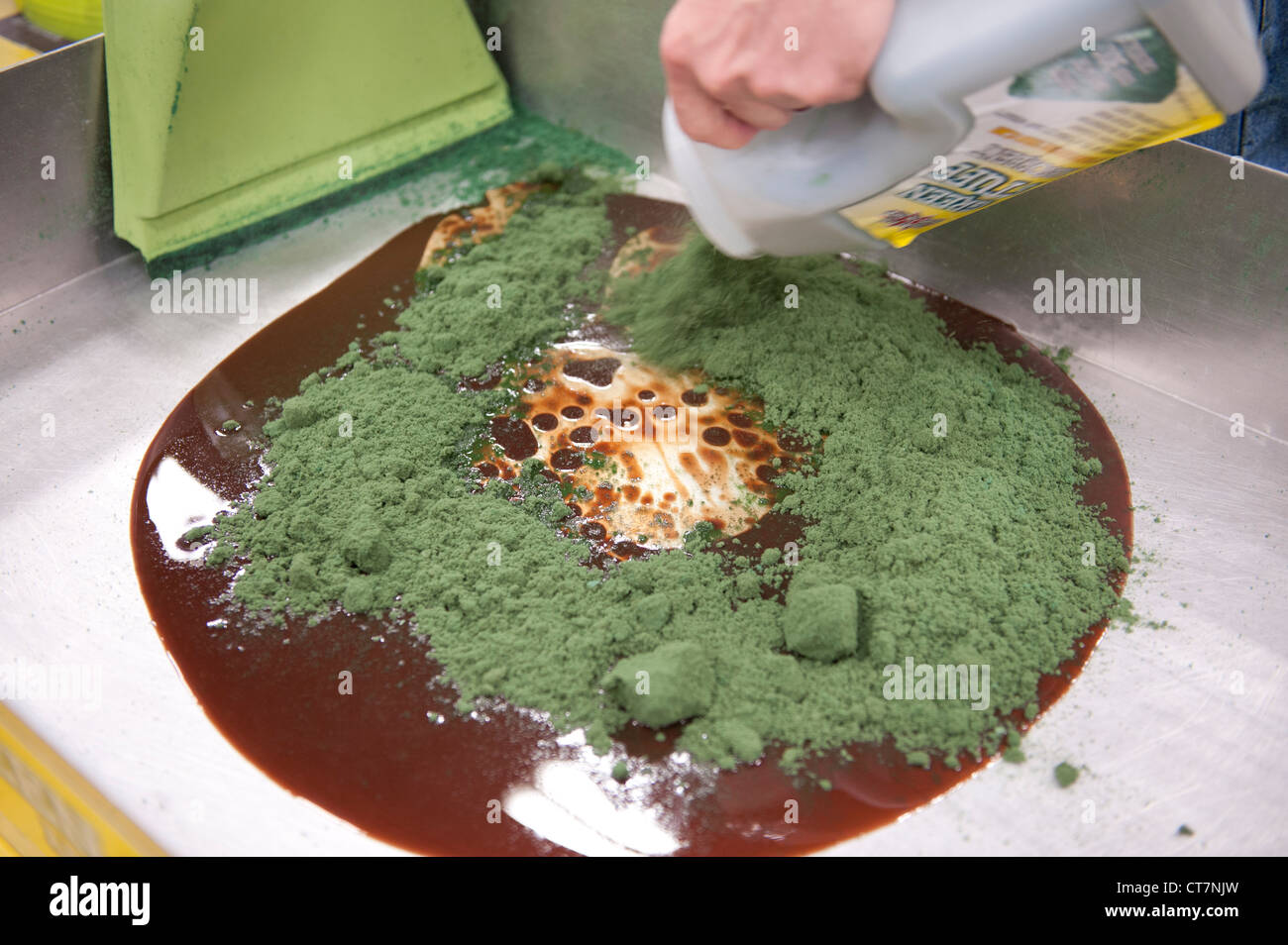 Hazardous materials absorbent "Green Stuff" is used on sample oil and