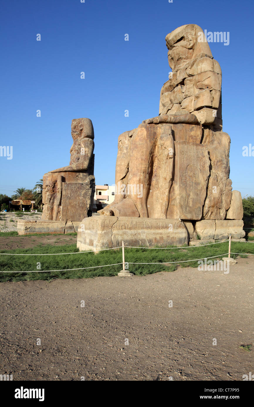 The Colossi of Memnon, the massive stone statues of Pharaoh Amenhotep III, Luxor, Egypt Stock Photo