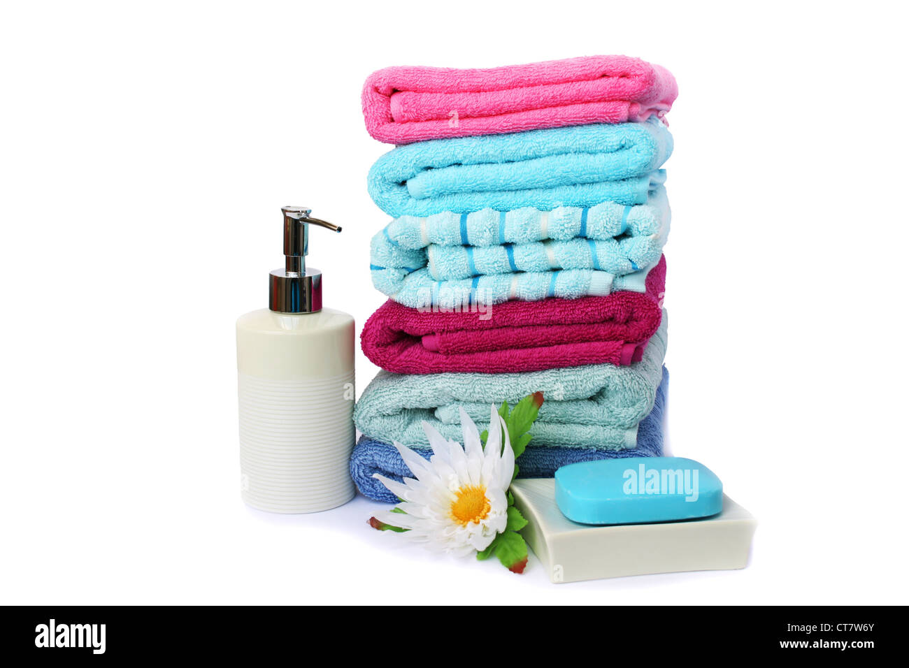 Stack of towels, soaps and flowers isolated on white background. Stock Photo