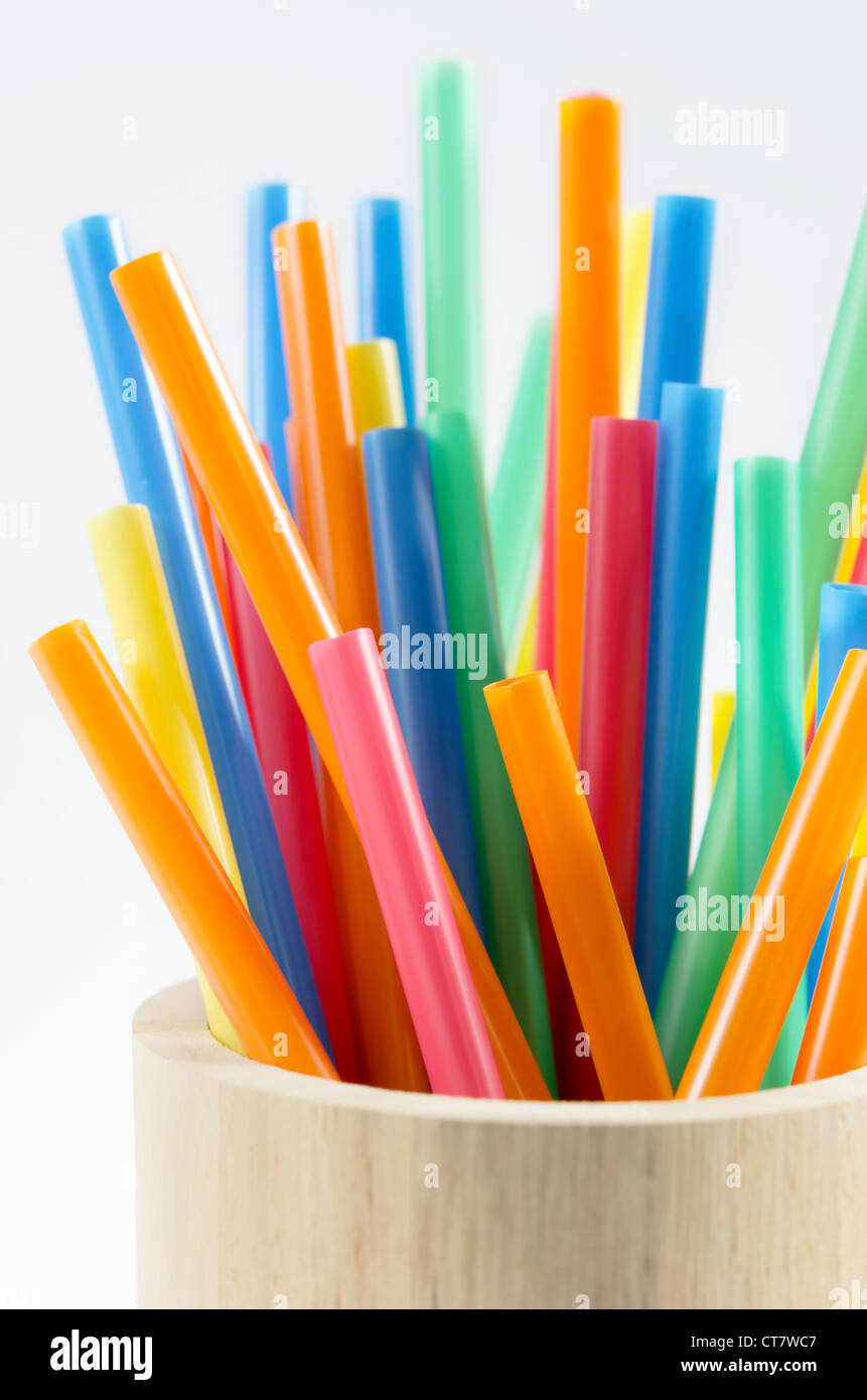 colorful drinking straws in wooden cup . Stock Photo