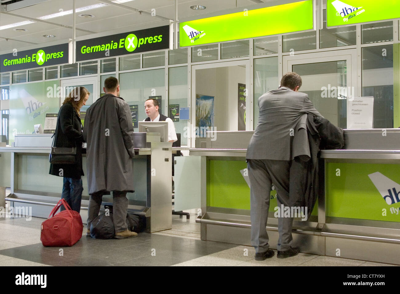 Munich, travelers on a counter of the airline Germania and the DBA Stock Photo