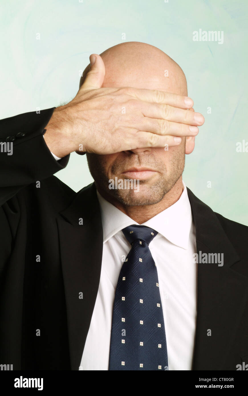 Man with hand over eyes Stock Photo Alamy