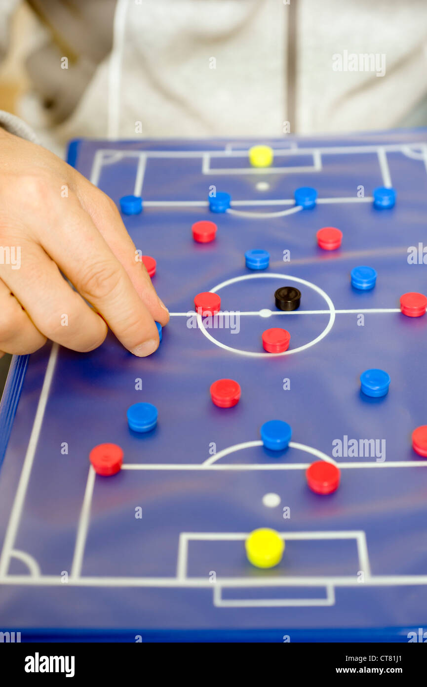 soccer trainer showing schemes on a tactic board Stock Photo