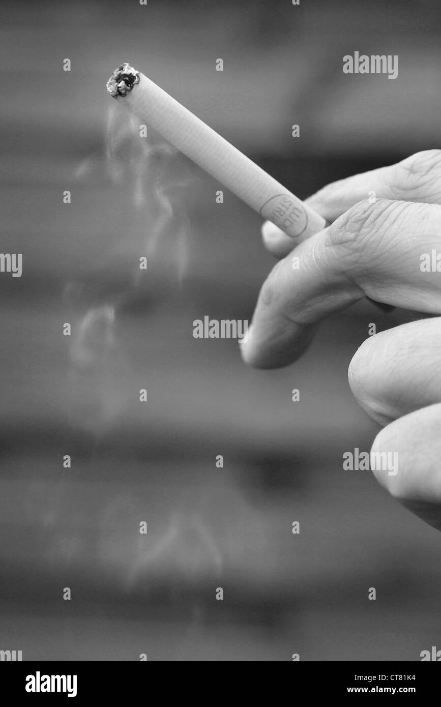 Maennerhand with cigarette Stock Photo