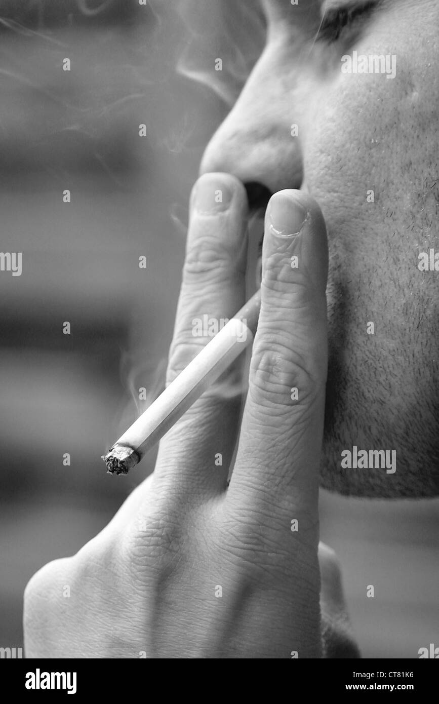 Man pulls enjoyable on a cigarette Stock Photo