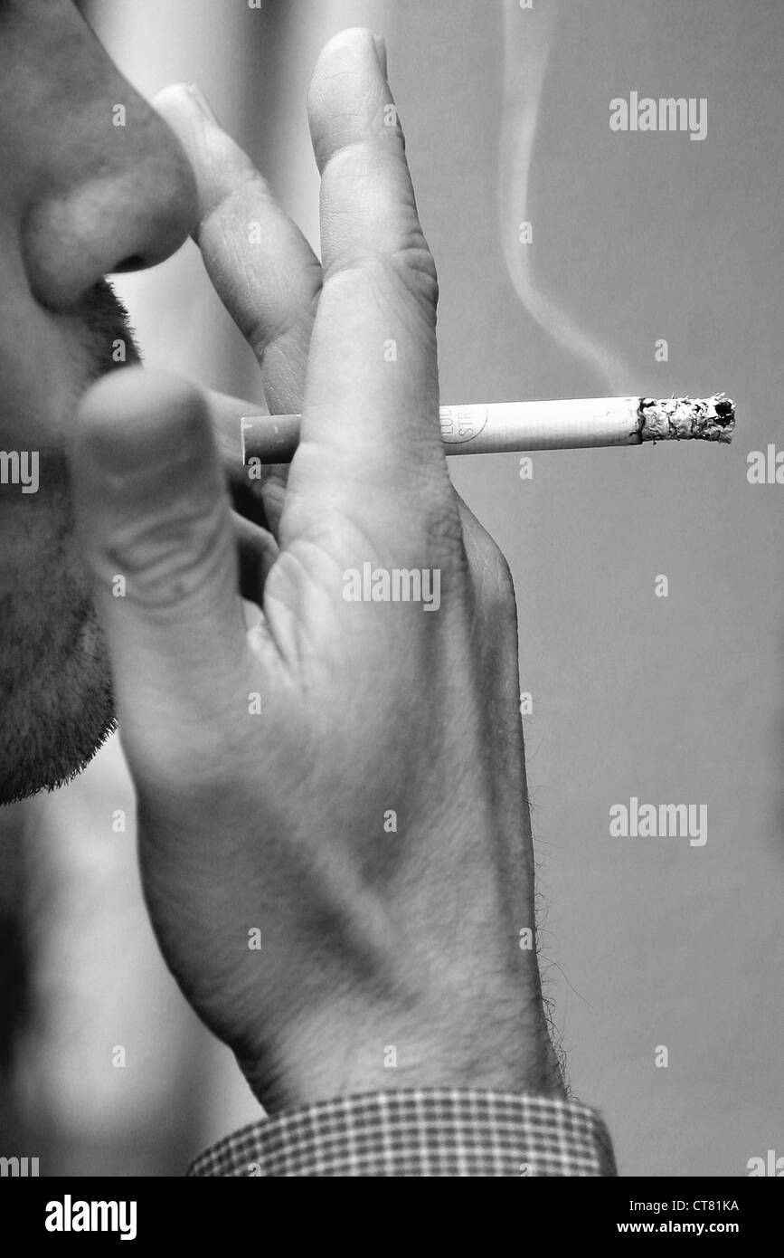 Man pulls enjoyable on a cigarette Stock Photo