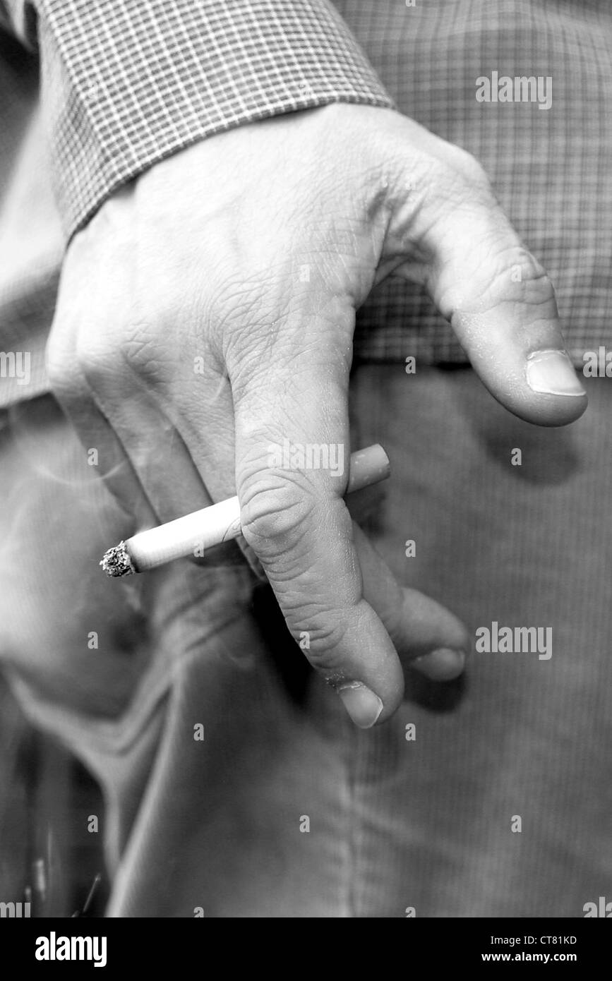 Maennerhand with cigarette Stock Photo