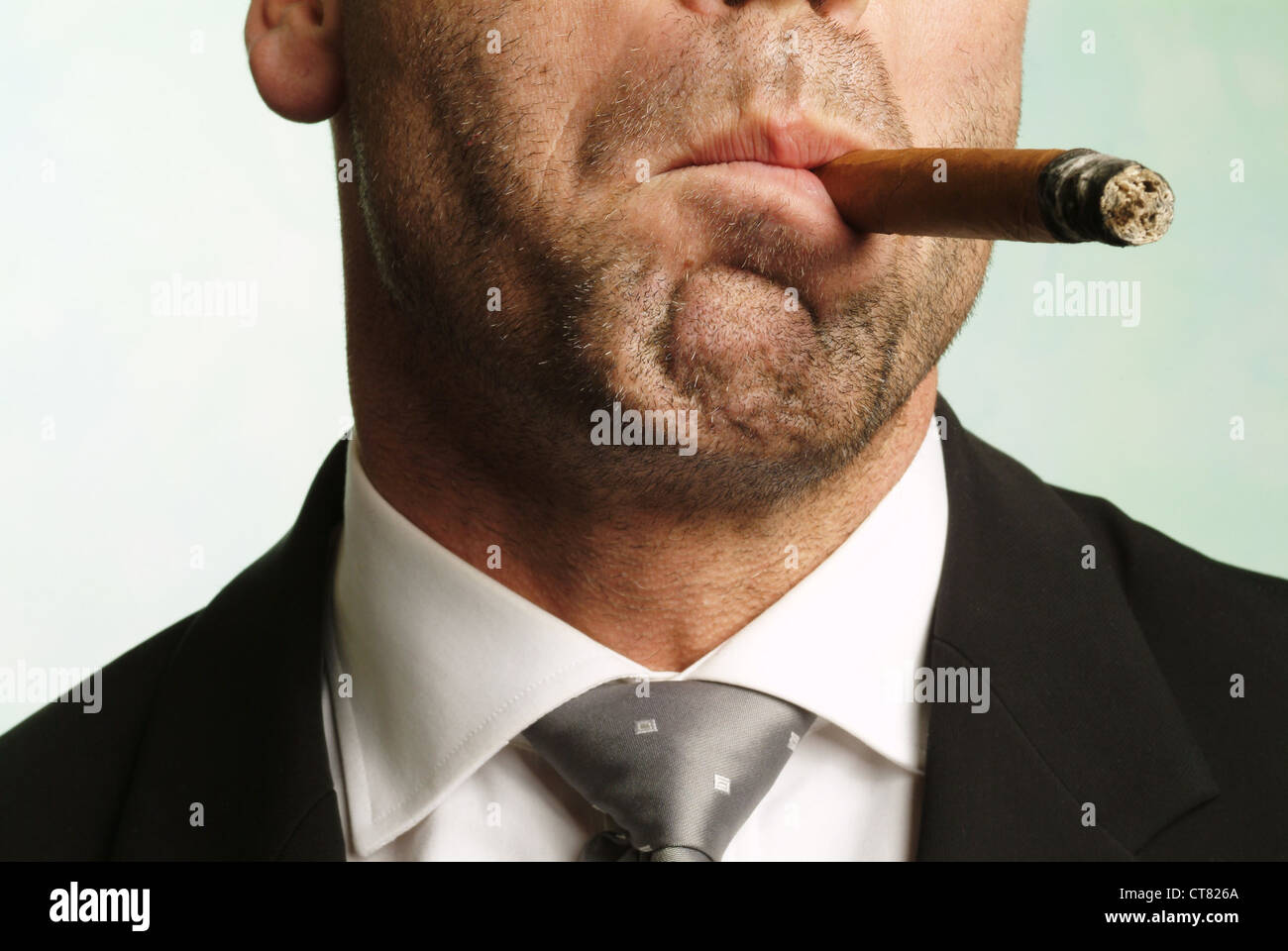 Pleasurable man smokes a cigar Stock Photo