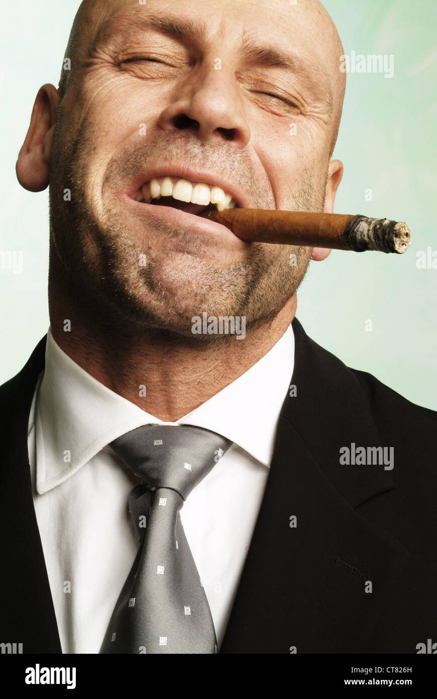 Pleasurable man smokes a cigar Stock Photo