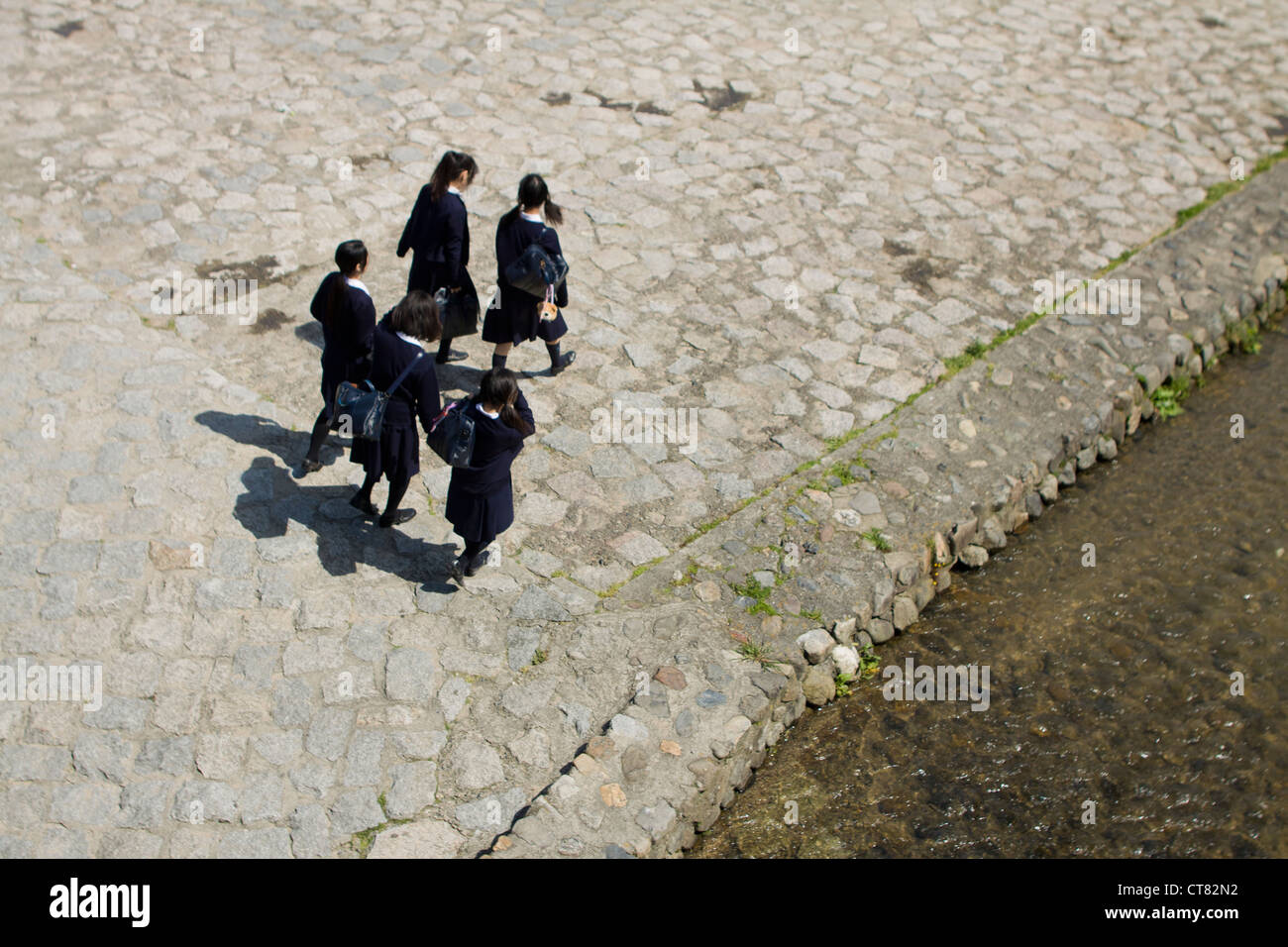 A group of Japanese school children walking in Kyoto, Japan Stock Photo