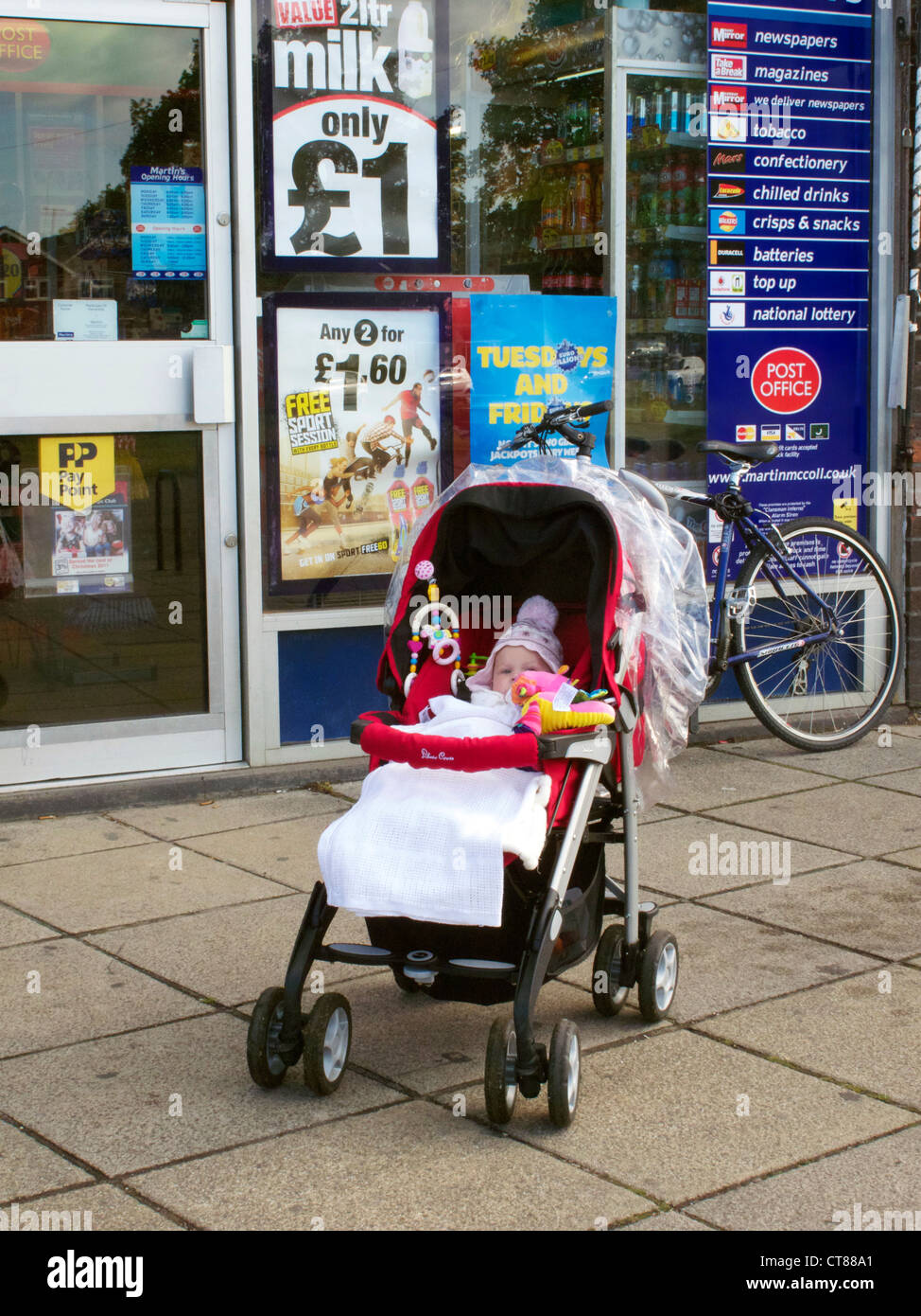 Baby left in pushchair in a poor area. Caldecott, Abingdon, Oxfordshire. Model Released. Stock Photo