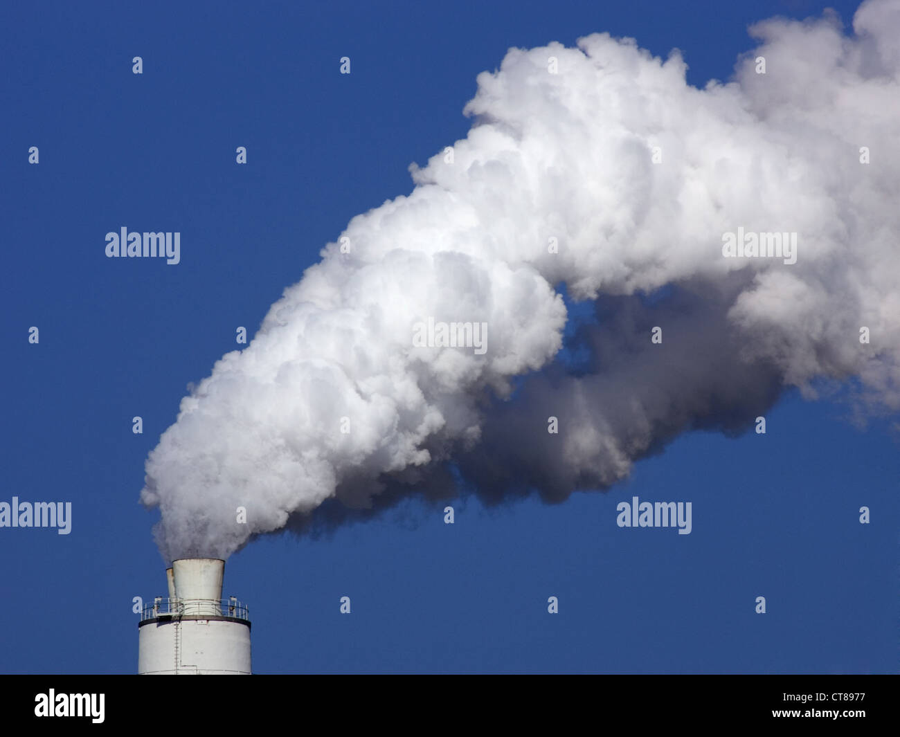 Symbol photo, exhaust in the form of white smoke escape a chimney Stock Photo