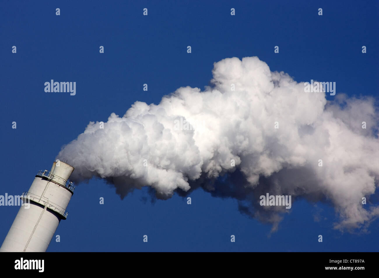 Symbol photo, exhaust in the form of white smoke escape a chimney Stock Photo