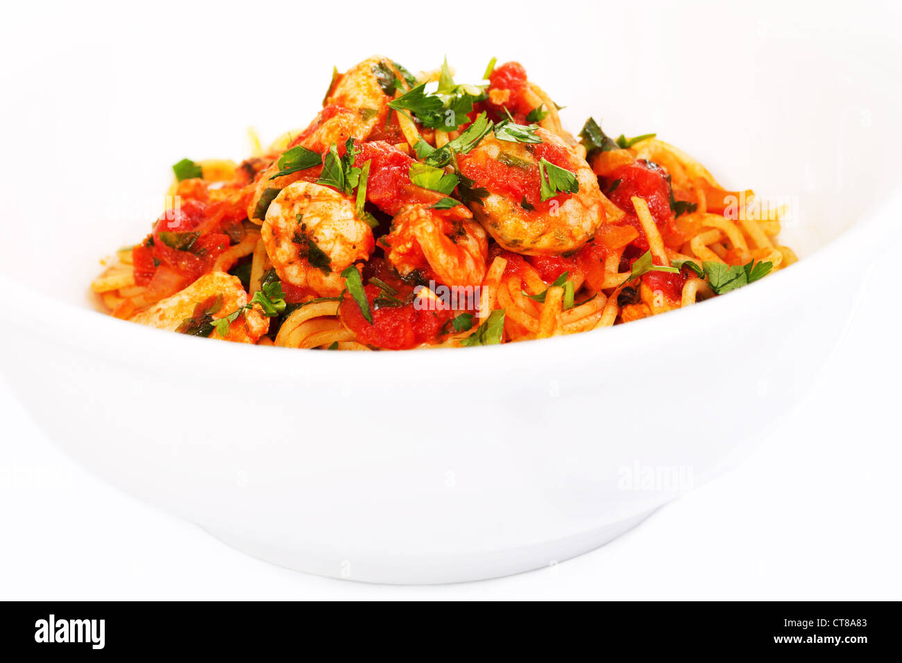 Spaghetti tomato seafood dish in white bowl Stock Photo
