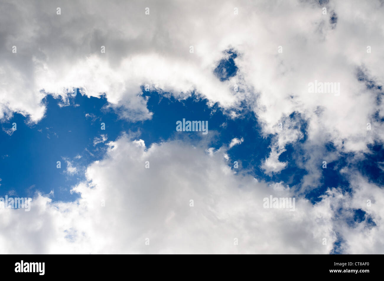 Fluffy clouds in a blue sky sky Stock Photo - Alamy