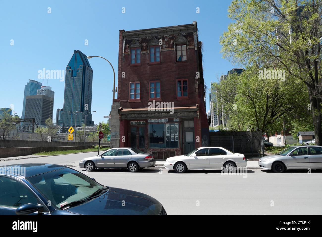 Derelict building on corner of Rue St. Paul West Ouest contrasts with modern corporate architecture Montreal, Quebec, Canada Stock Photo