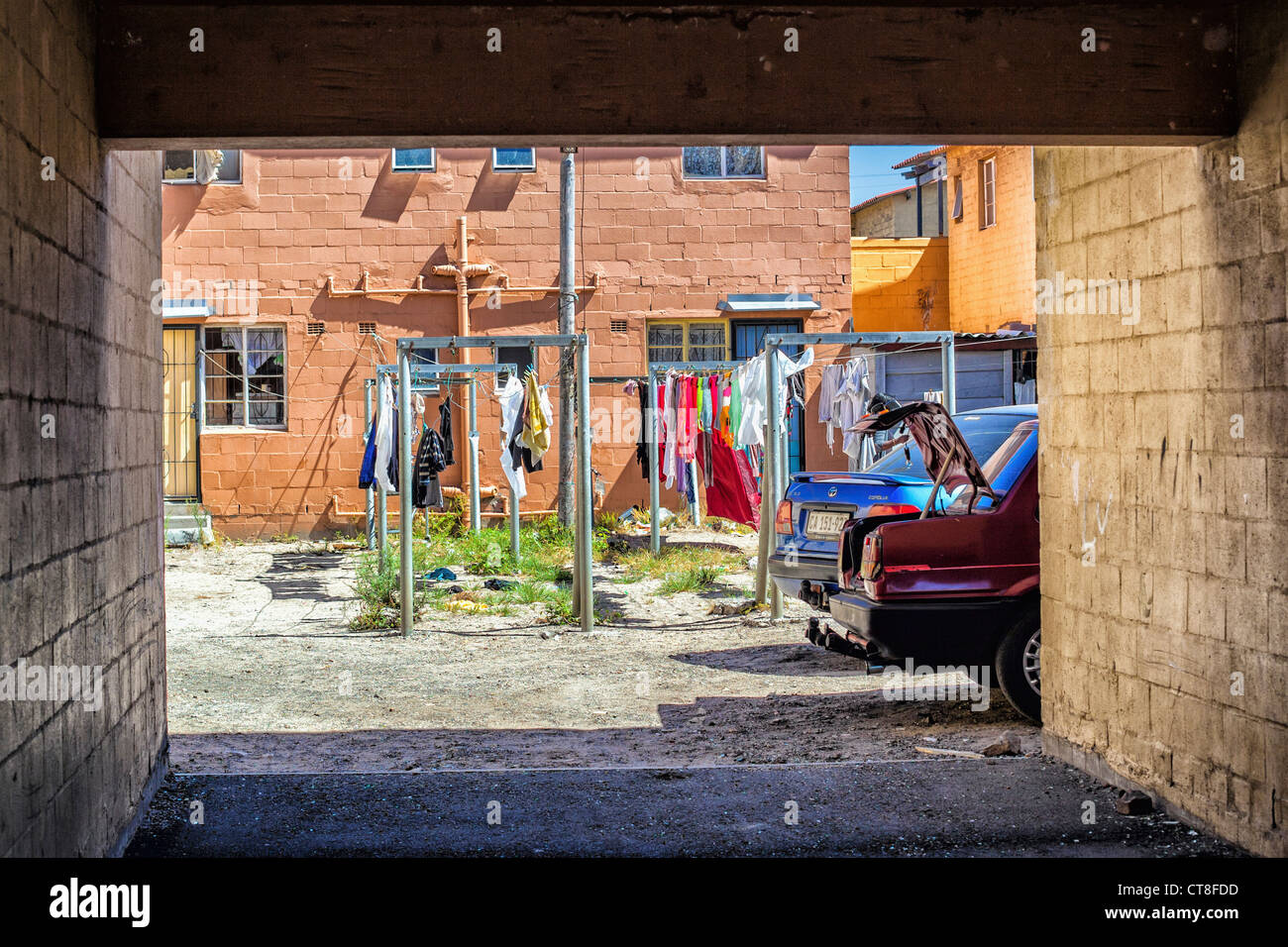A view of a courtyard, washing lines and cars in Langa African Township near Cape Town, South Africa Stock Photo