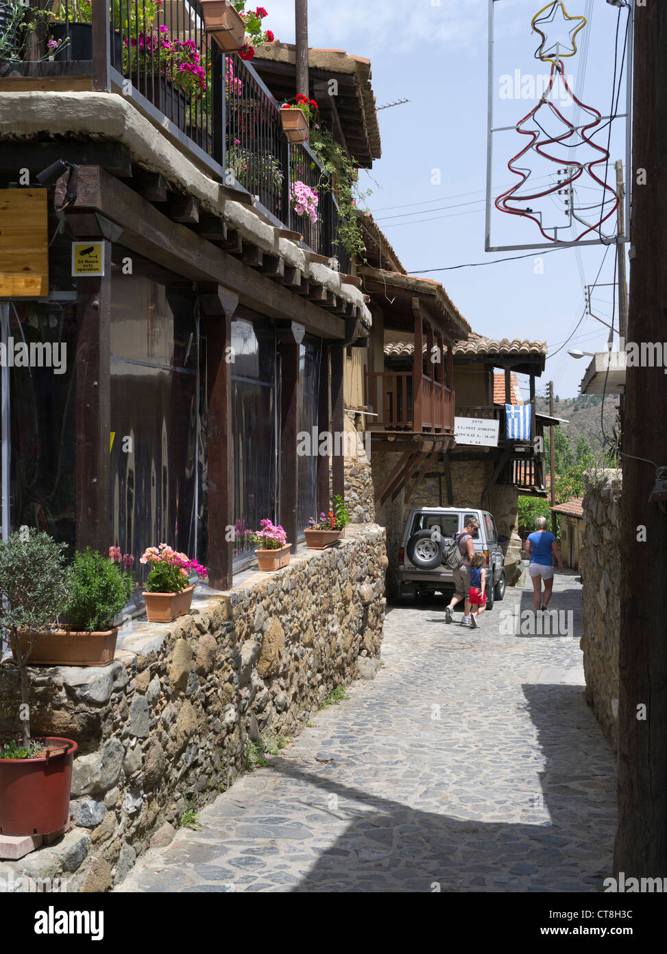 dh Old Troodos mountain village KAKOPETRIA SOUTH CYPRUS Tourist family street alley mountains people greece attraction villages Stock Photo