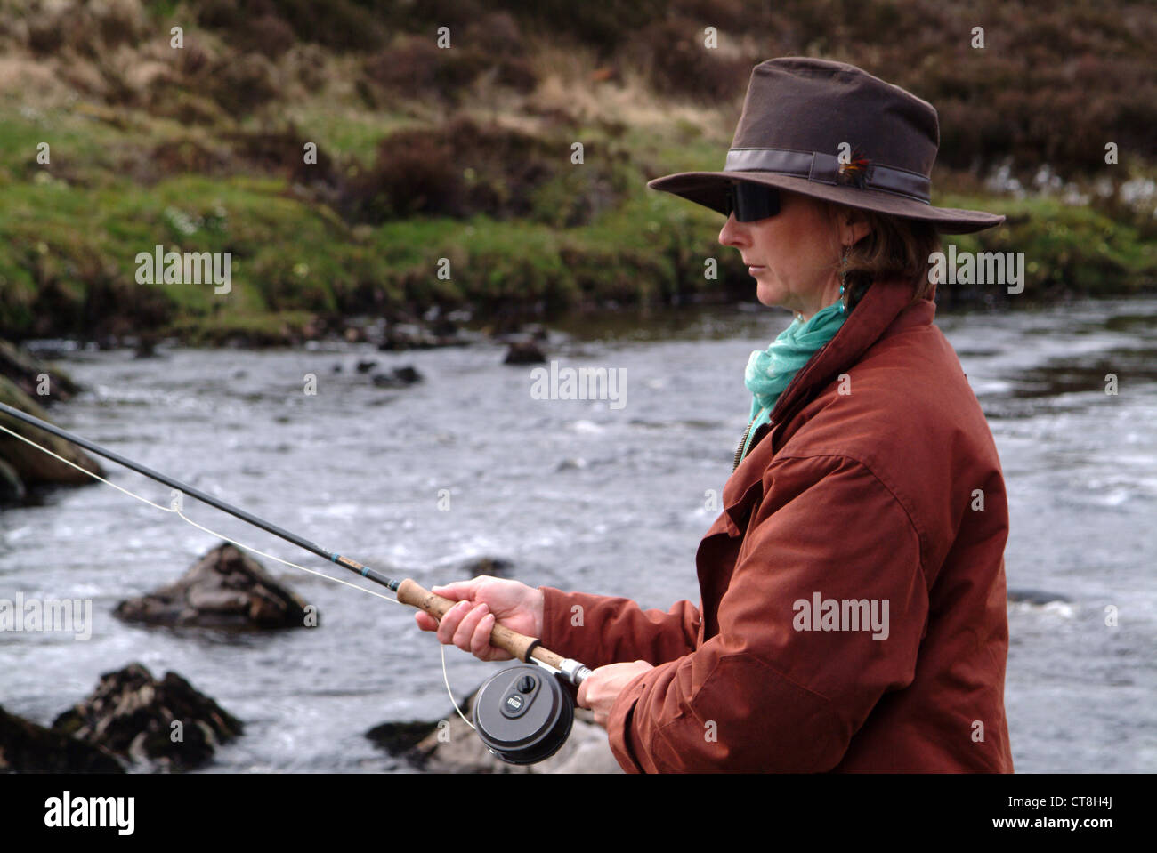 Woman fly fishing in Scotland, UK Stock Photo - Alamy