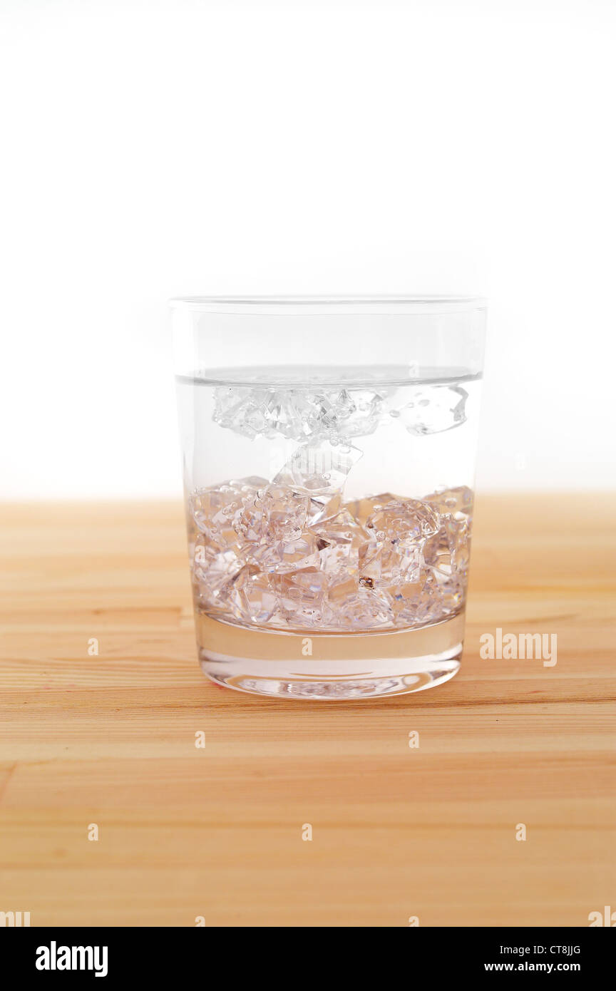 glass of pure ice water over a wood table white background Stock Photo ...