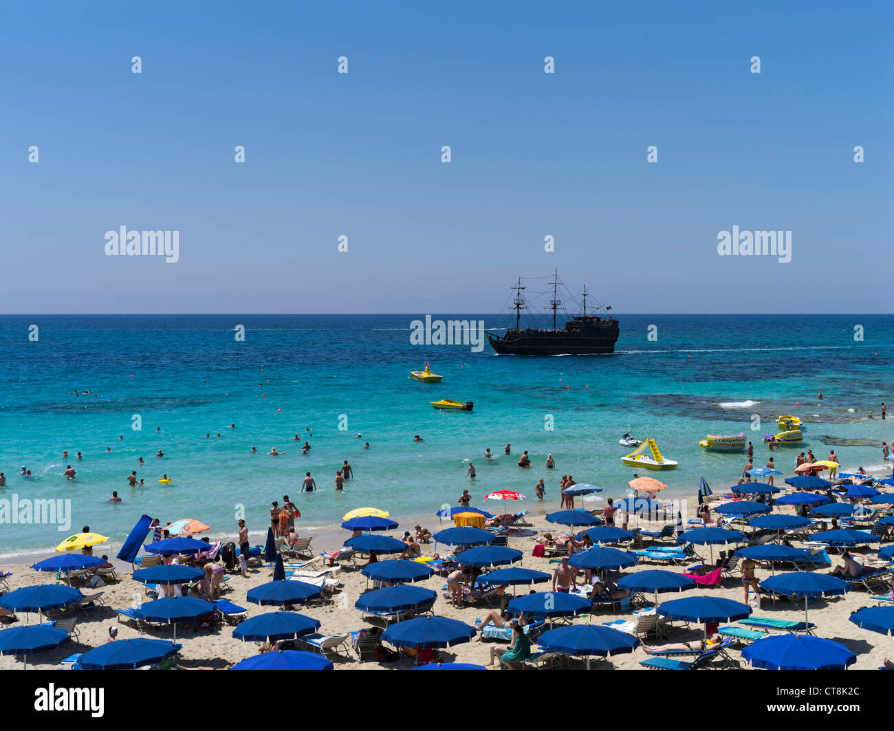 dh Grecian Bay AYIA NAPA CYPRUS Black Pearl Pirate ship Sun umbrellas beach sunbathers swimmers beaches Stock Photo